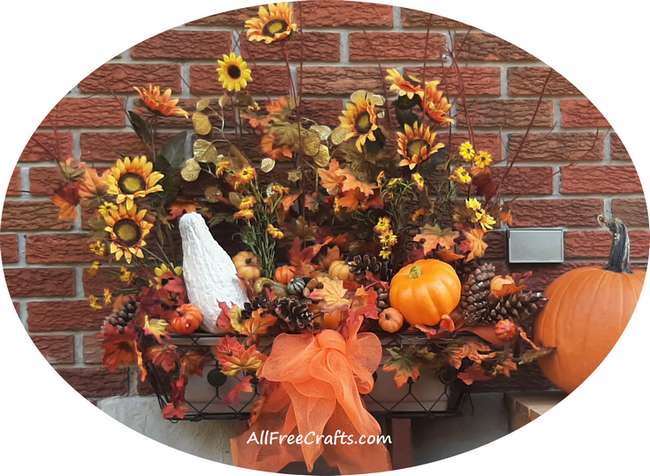 fall window box with gourds, pumpkins, fall leaves