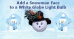 white globe light bulb painted with adorable snowman face