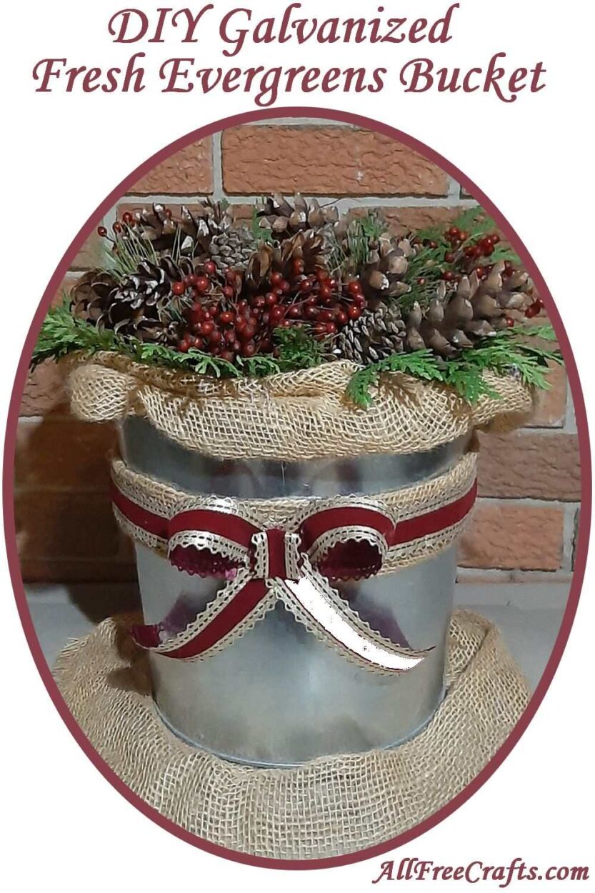 galvanized bucket of evergreens and pine cones with burlap