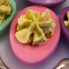 pink deviled egg with decorative piped filling